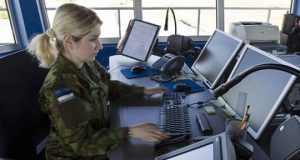 Estonian female soldier in front of computers