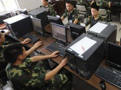 Chinese soldiers in front of computers