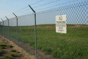 Chain link fence with a no trespassing sign